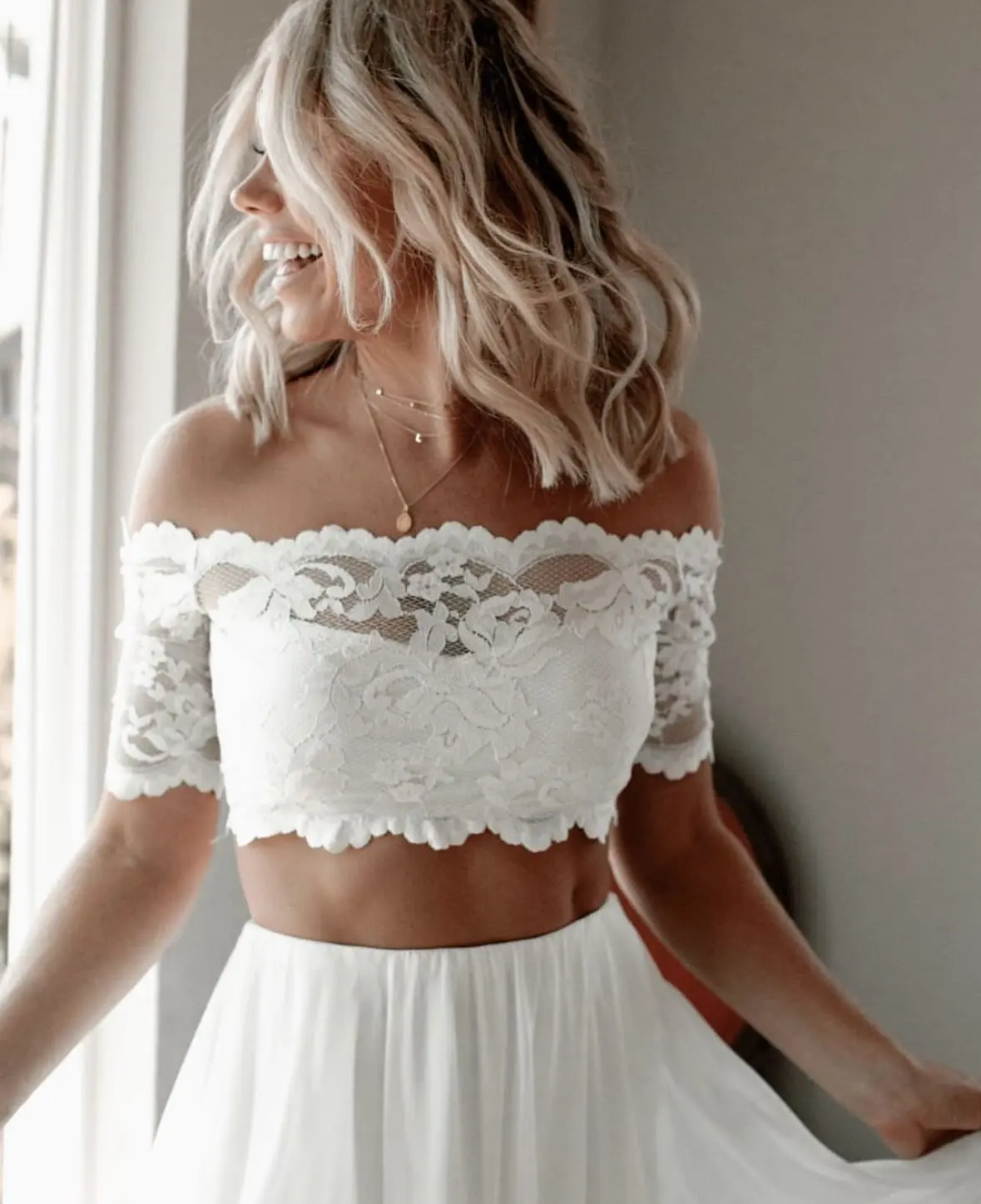 Woman whose hair & makeup has been done for her wedding by Glow+Co